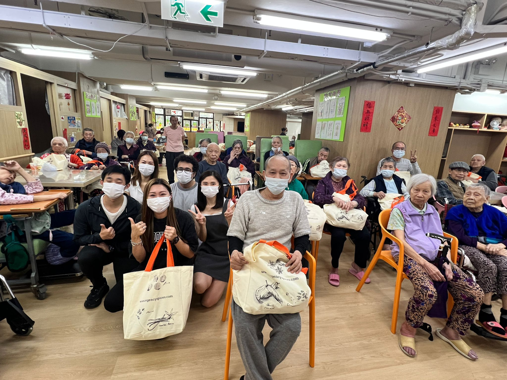 Volunteers and elderly residents together at a community centre