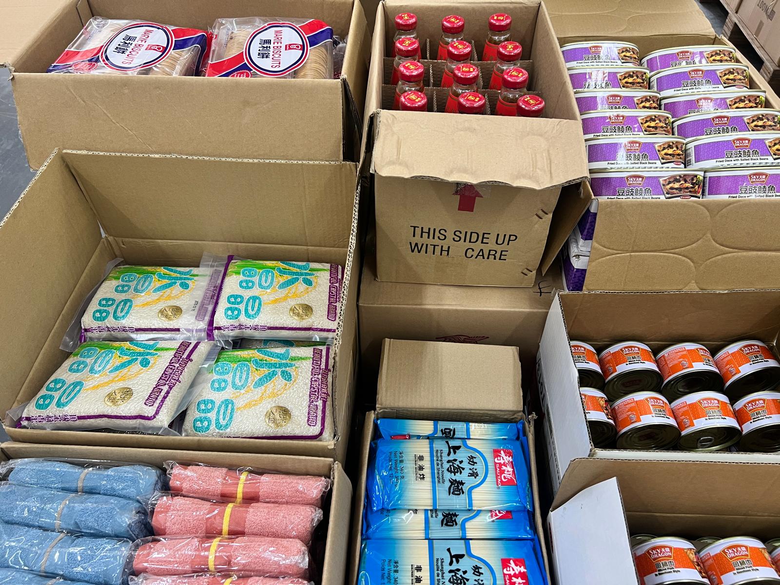 Boxes packed with rice, oil, canned fish and instant noodles ready for distribution